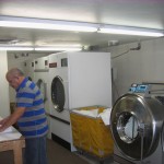 Two commercial washers and three large capacity dryers are his co-workers.